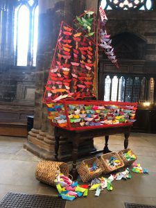 Christian Aid prayer boats offered by supporters displayed in the cathedral nave