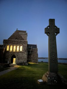 Iona Abbey and a standing cross at dusk