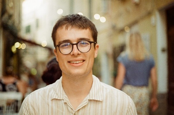 A headshot of Adam Aucock