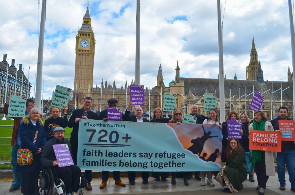 Banner - 720+ faith leaders say refugee families belong together - held by faith leaders outside parliament